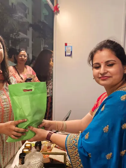 Handing over a purchase to another lovely customer. Each sale is a reminder that my hard work is bringing joy to others.