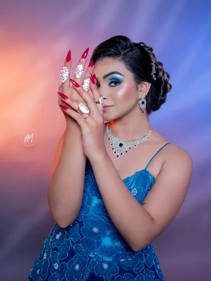 A playful pose that highlights the long, decorative nails and the beautiful rings available to rent with our outfits.