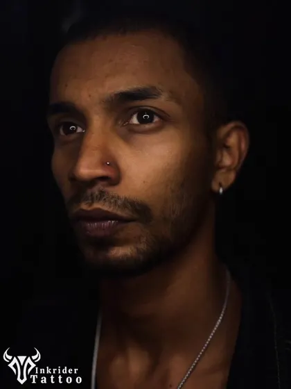 A moody portrait showcasing a subtle nose stud. Even small piercings can make a big impact on your look.