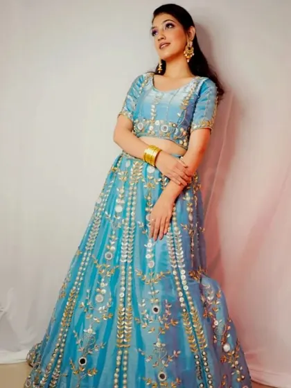 A full-length view of the beautiful powder blue mirror work lehenga. The color is fresh and modern, while the traditional craftsmanship makes it timeless.