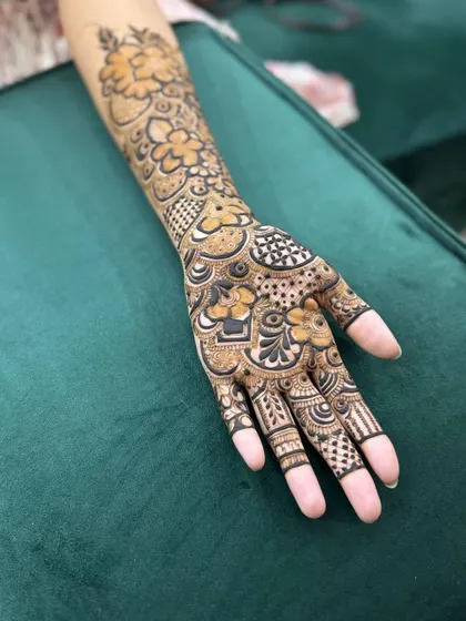 Another angle of the bride's sister's mehendi, showing the detailed work on the palm and fingers.
