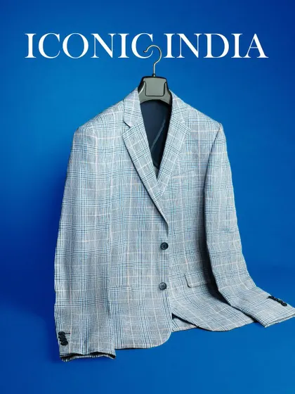 A clean, catalog-style shot of a men's blazer from Iconic India against a solid blue background. This type of image clearly shows the product's color, pattern, and shape.