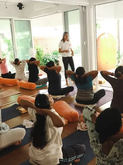 A class in session, focusing on neck and shoulder release. Our bright, airy studio provides the perfect backdrop for students to find space in their bodies and minds.