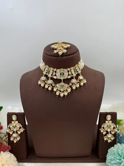 This collection showcases our premium Moissanite Kundan necklaces like the 'Noor Nazaakat' and 'Darbaar' sets. Each comes with a full set of earrings and maang tikka, available in various color combinations.