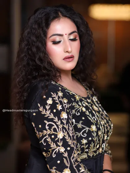 A close-up of the makeup from our curly-haired model shoot. The focus is on the expertly blended eyeshadow and the soft, matte finish on the skin.