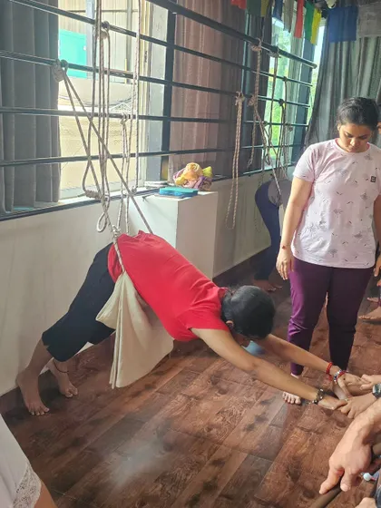 Another variation of a supported Downward-Facing Dog using ropes, perfect for decompressing the spine and opening the shoulders.