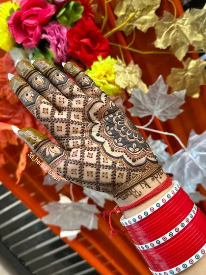 A vibrant shot of a full 'jaal' or net pattern on the back of the hand, set against a colorful floral background. This is a classic and timeless bridal choice.