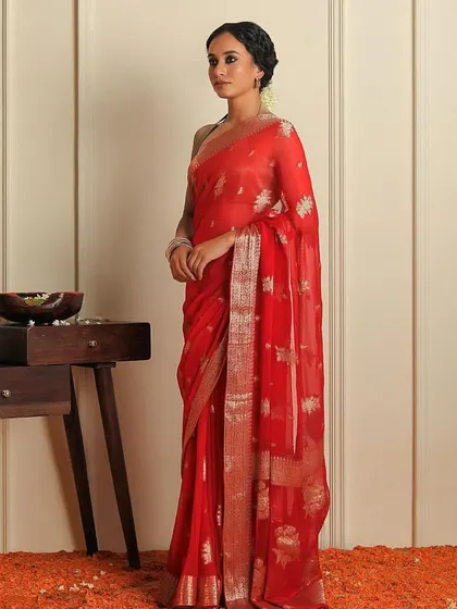 A full-length shot of a classic red saree for Binal Patel's "Rubaroo" festive edition. The set was styled with traditional elements like marigold flowers to create an authentic, celebratory atmosphere.