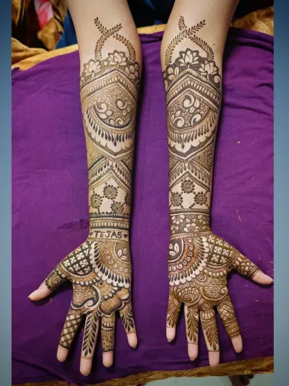 A clear top-down view of a symmetrical bridal design. You can see the groom's name 'Tejas' neatly written on the wrist, a personal touch I love to add.
