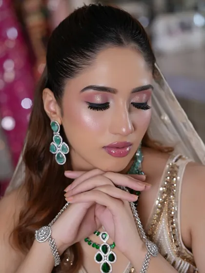 A beautiful close-up of the eye makeup. The soft pink tones and flawless blending create a look that is both gentle and captivating.