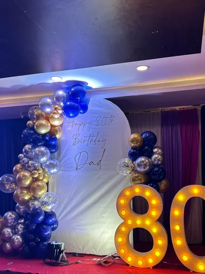 The complete stage setup for the 80th birthday party, ready for the guest of honor and his family.