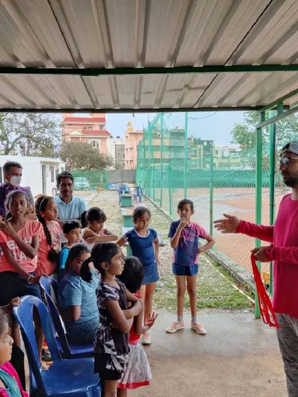 Coaching is about clear communication and building confidence. One of our coaches explains a drill to an attentive group of young players before they hit the court.