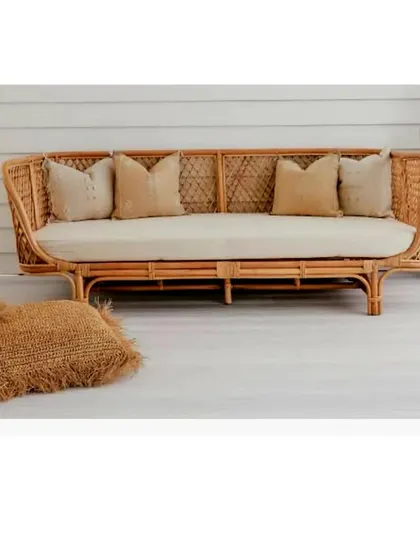 Designed for ultimate relaxation, this deep-seated rattan daybed offers a spacious and comfortable retreat. Its sturdy, handwoven frame and plush cushions make it a perfect addition to a covered patio, sunroom, or a cozy corner in a large living area.