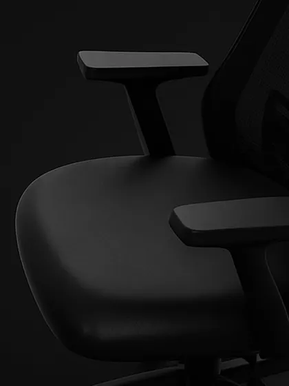 This close-up focuses on the adjustable T-shaped armrests and the contoured seat of our ergonomic chair. These elements are designed to reduce strain on your shoulders and provide a comfortable seating foundation.