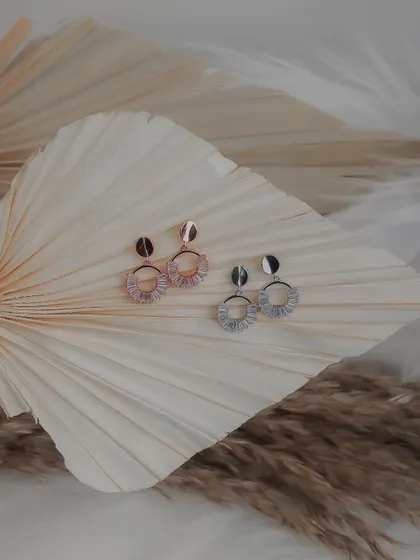 Styled shot of elegant hoop earrings for an e-commerce store. I used dried palm leaves as a prop to create a natural, bohemian vibe that complements the jewelry's design.