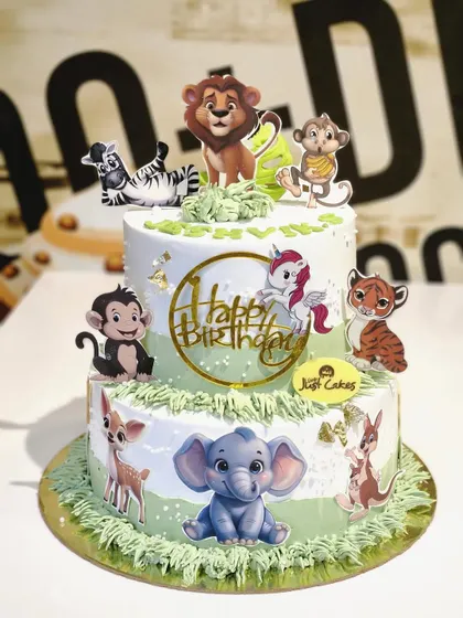This 4kg two-tiered jungle animal cake uses a mix of edible prints and a unicorn topper for a whimsical safari party.