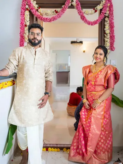 A portrait of the happy homeowners at their doorstep. This photo captures the pride and joy of starting a new life together in their very own space.