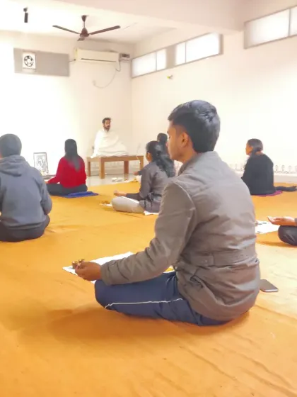 Participants sit with focus, holding the materials used for the elemental purification process.