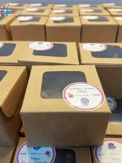 Our homemade modaks are carefully packed in boxes for the children to take home. They feel a great sense of pride in sharing their creations with their families.
