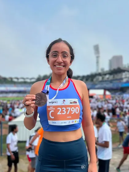 Holding my podium-finish medal from my first half marathon. This photo represents months of dedication and the joy of achieving a goal that once felt impossible.