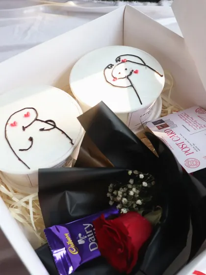 A different angle of the "XOXO" hamper, showing the postcard and chocolate bar included.
