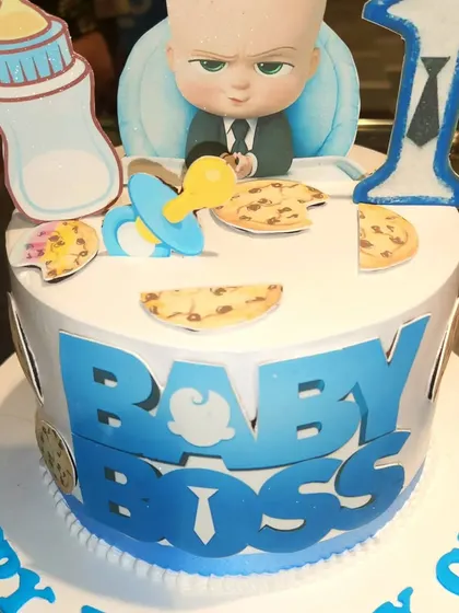 Who's the boss? This Baby Boss theme cake is perfect for a first birthday, complete with a milk bottle, pacifier, and the boss himself.