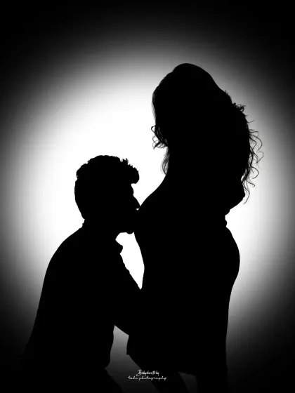 A dramatic silhouette captures the profound connection between partners. In this black and white portrait, the focus is purely on the emotion and the beautiful shape of new life, a powerful memory for you to hold onto.