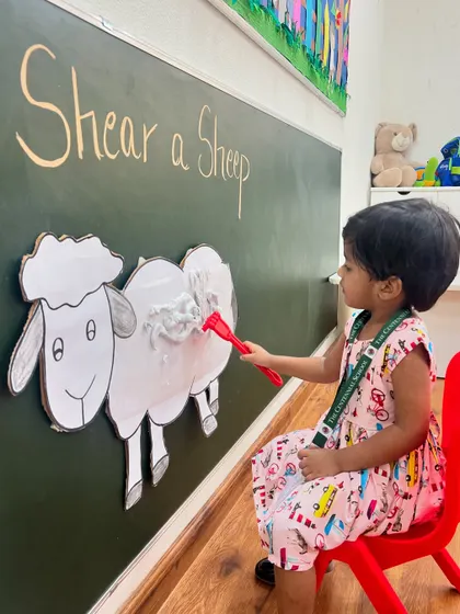 Each child gets a turn to be the farmer. This activity not only teaches about sheep and wool but also helps develop fine motor skills and hand-eye coordination.