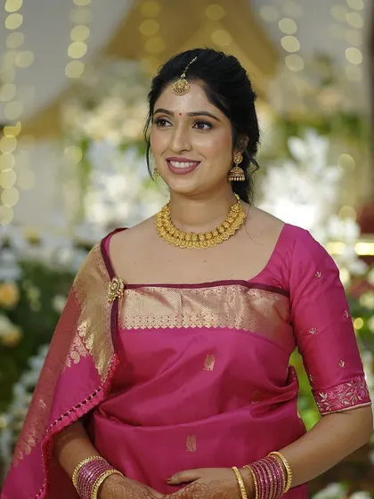 A close-up of the bride's happy face. Her makeup enhances her features without looking heavy, perfect for this traditional ceremony.