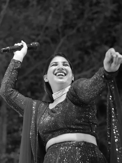 A joyful, black and white candid shot from a sangeet night. This image perfectly captures the pure happiness and high energy of the celebration.