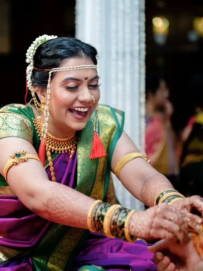 A moment of laughter and fun during the rituals. Poorva is all smiles as she participates in one of the wedding ceremony traditions.