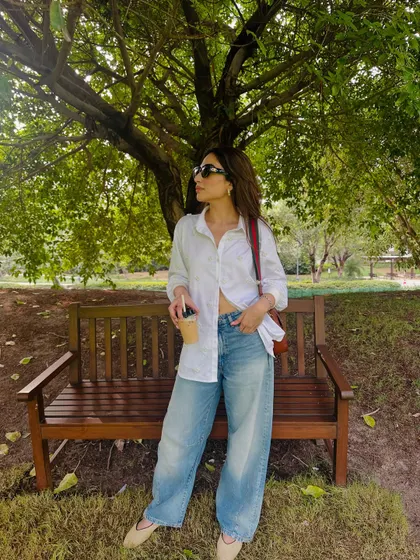 Enjoying a coffee in the park in my comfy shirt and jeans.