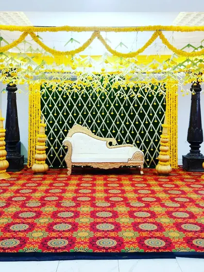 A slightly different angle of the indoor mandap, highlighting the decorative brass pots that flank the seating area. These small details enhance the traditional feel of the ceremony space.