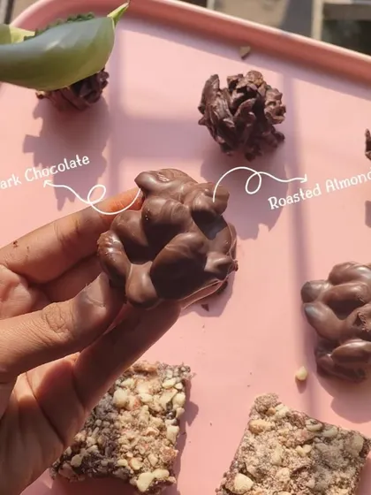 This is my classic Almond Rock. I take whole roasted almonds and generously coat them in smooth, dark chocolate to create this timeless confection.
