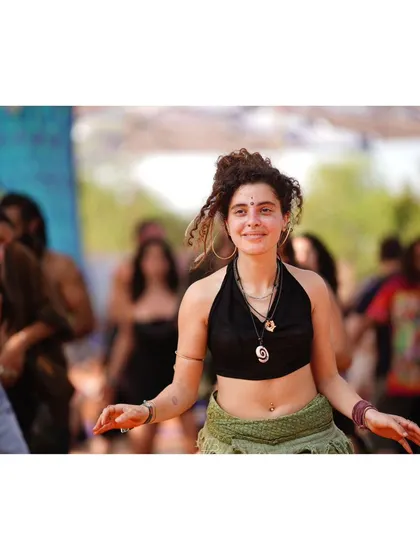 Another beautiful, candid portrait from a festival. Her smile and the energy of the crowd around her tell a story of community and celebration.
