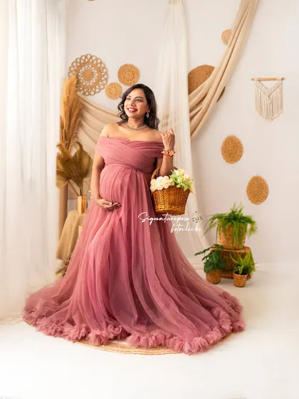 A joyful portrait in the boho studio, with a basket of flowers adding a fresh, rustic touch.
