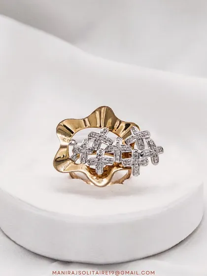 I love playing with shapes and textures. This unique ring features a cluster of small, cross-shaped diamond settings on a beautifully sculpted gold band. It's a modern piece with an artistic touch.