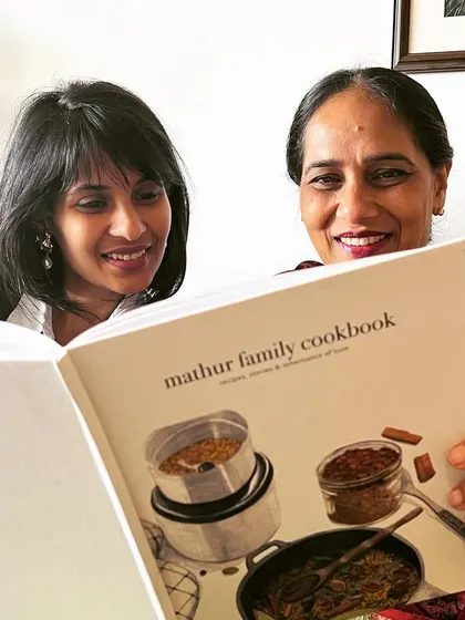 Advaeita and Nupur Mathur with their precious heirloom, a beautifully designed family cookbook we created for them. In most families, food is a love language, and we help you document it.