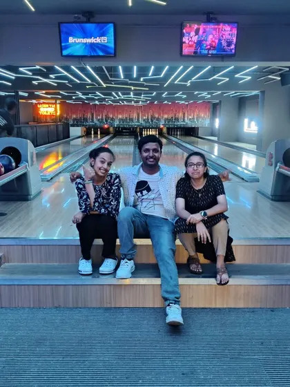 A group of friends relaxing and posing for a photo at our bowling alley.