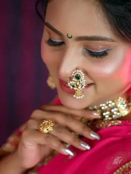 A close-up shot titled 'Maratha Moli', focusing on the bride's beautiful nath and expressive eyes. This portrait is a celebration of Maharashtrian bridal tradition.