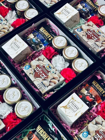 The vibrant colors of the flowers and shredded paper inside the favor boxes create a festive and inviting look.