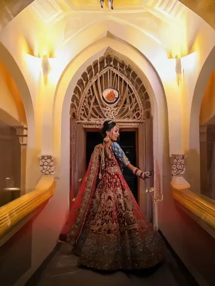 The bride twirls in her stunning lehenga, creating a beautiful motion shot that showcases the full glory of her wedding dress.
