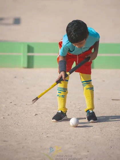 A young boy from our 2022 camp, carefully controlling the ball.