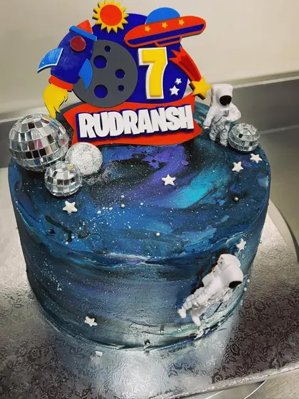 Need some space? This galaxy-themed cake is perfect for a young astronaut's birthday. It features deep blue and purple buttercream, disco ball planets, and an astronaut topper for an out-of-this-world celebration.