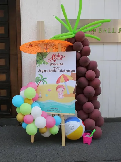 The entrance to our Hawaiian "Joyous Little Celebration." A custom welcome sign and a palm tree made of balloons set a fun, tropical tone from the moment guests arrived.