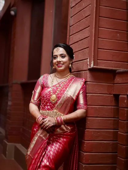 This bride looks confident and beautiful. Her makeup enhances her natural features, and her hair is styled in a classic updo.