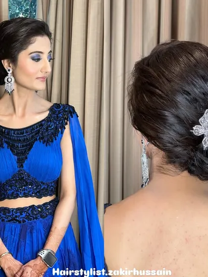 Here is a chic and elegant side-swept bun, perfect for a cocktail party or reception. I added a sparkling butterfly clip as a statement accessory to complement the client's royal blue gown.