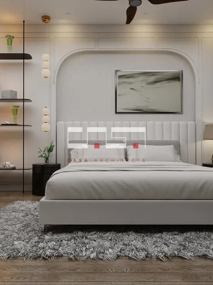 Another view of the elegant bedroom, showing the full space with its plush rug and simple, modern furniture.