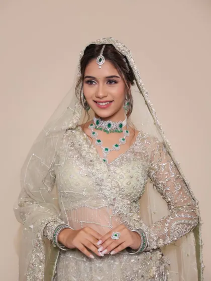 The full look with a sheer, embellished dupatta. This style is perfect for a Nikkah ceremony or a glamorous reception, combining tradition with modern elegance.