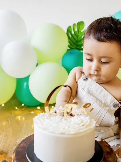 That moment of hesitation right before the fun begins. This little one is carefully inspecting his cake before making his first move.